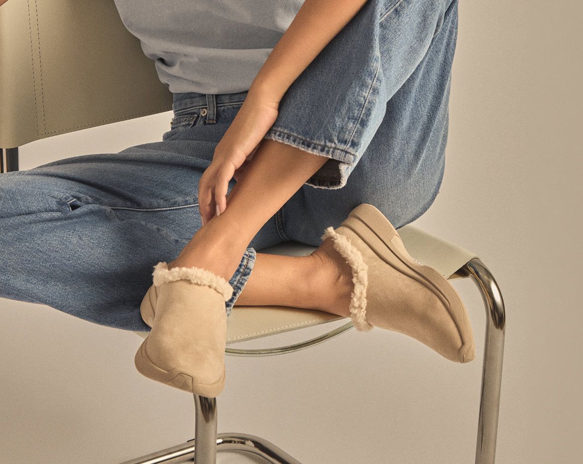 woman sitting on chair wearing  flory shearling mule