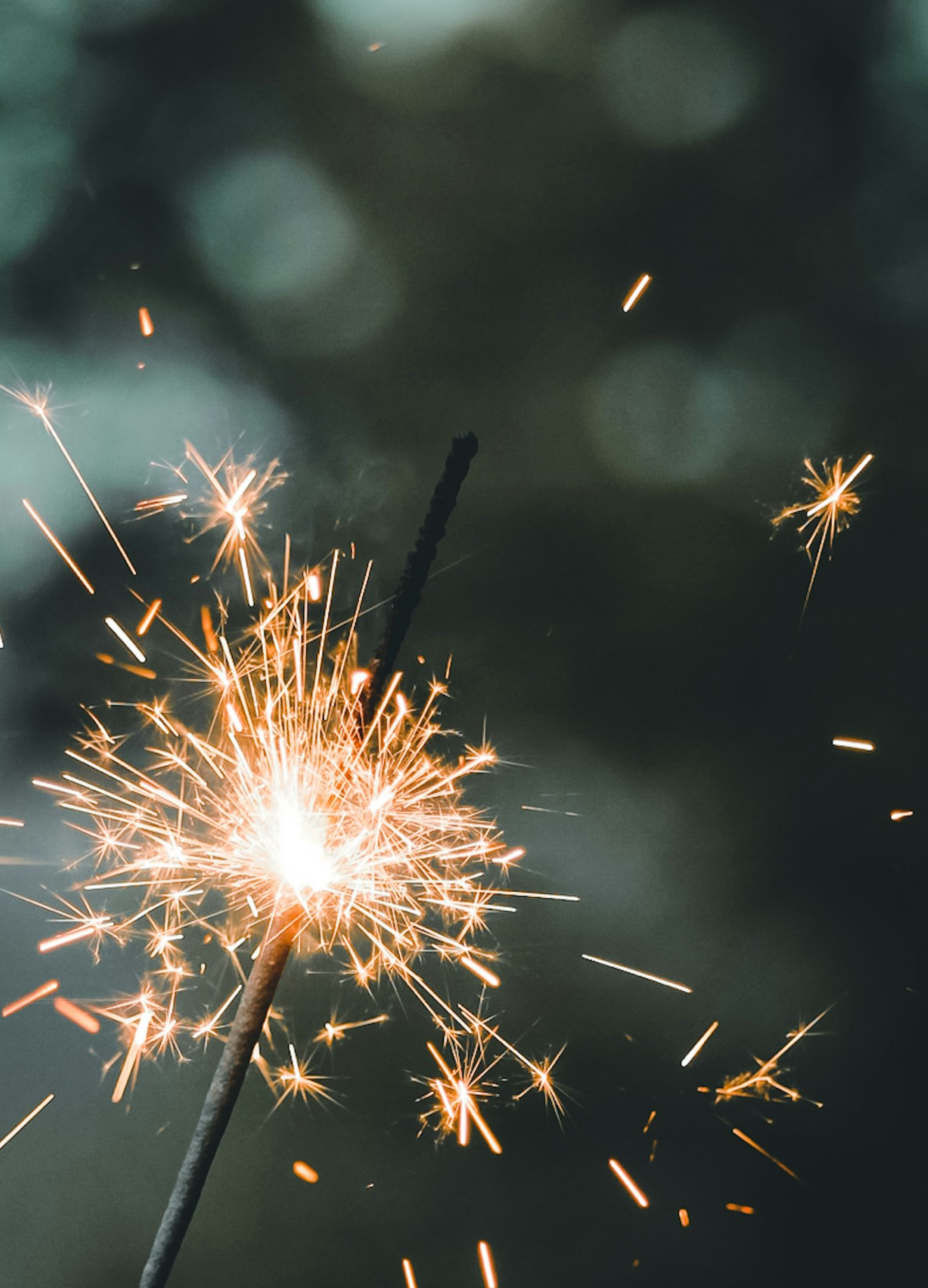 SPARKLER ON NIGHT SKY BACKGROUND