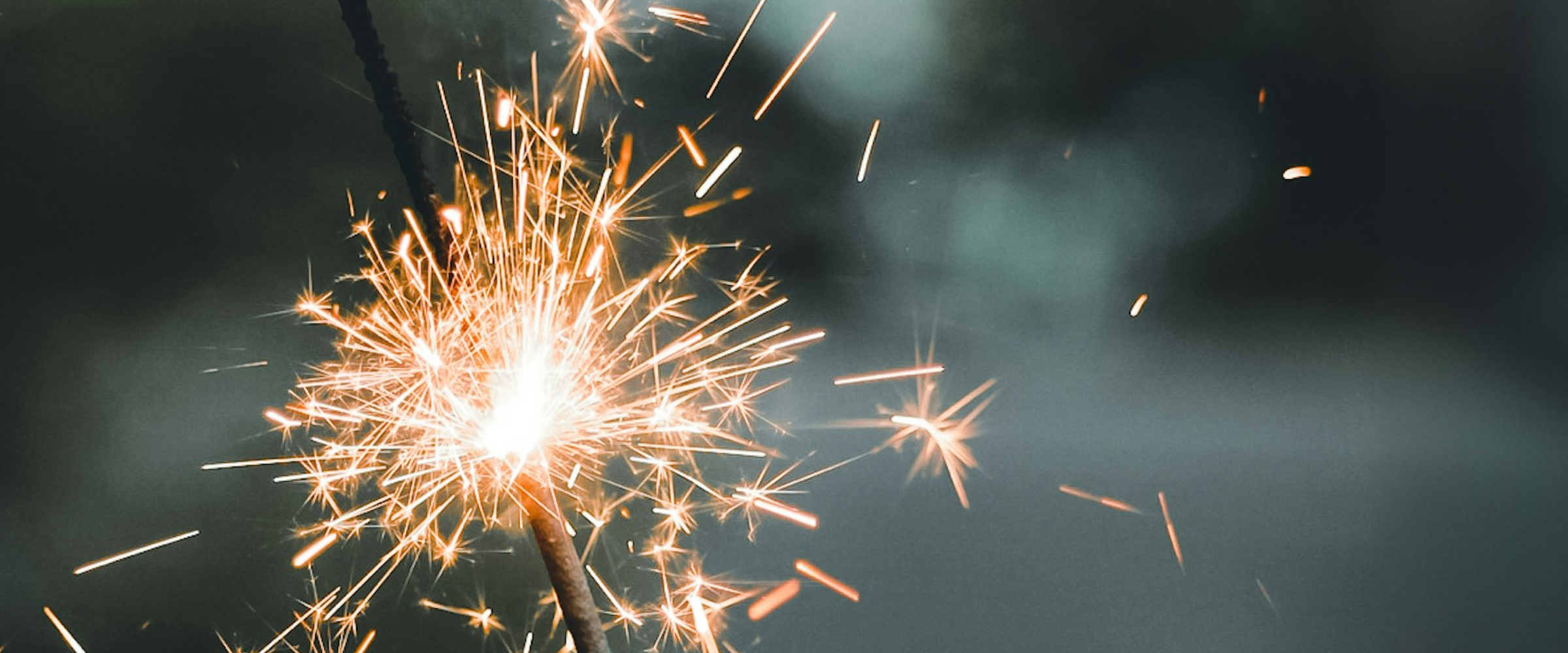 SPARKLER ON NIGHT SKY BACKGROUND