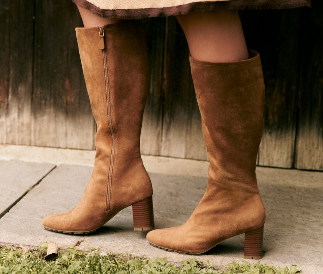 person wearing tall camel colored boots with heel