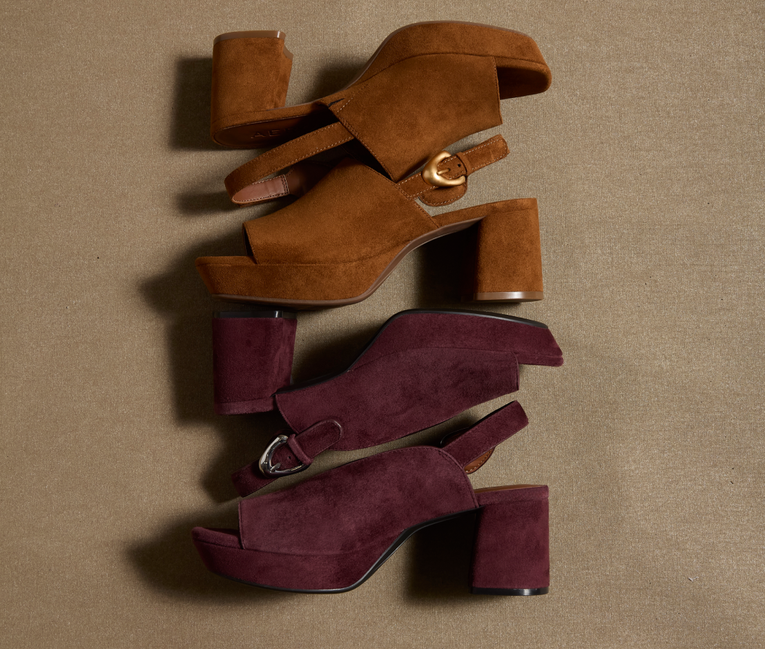 Four women's platform block-heel sandals in suede-like material, arranged vertically on a textured beige background. The top pair is a warm camel brown with gold-tone buckle details, and the bottom pair is a deep burgundy with silver-tone buckle details.